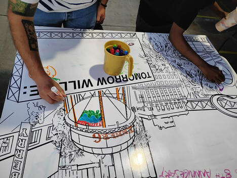 Two early participants drawing on the “BILLBOARDS” piece.