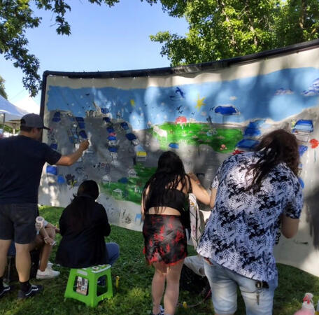 Participants of a community painting at Stockton Flavor Fest 2024.